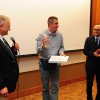 Award Ceremony (from left to right): John Martich, the President of the SNF, Zeljko Mirkovic with the “SNF Spirit Award,” the Movie Director of the “Tesla Nation,” and Milos Rastovic, the Cultural Outreach Coordinator of the SNF and Master of Ceremon